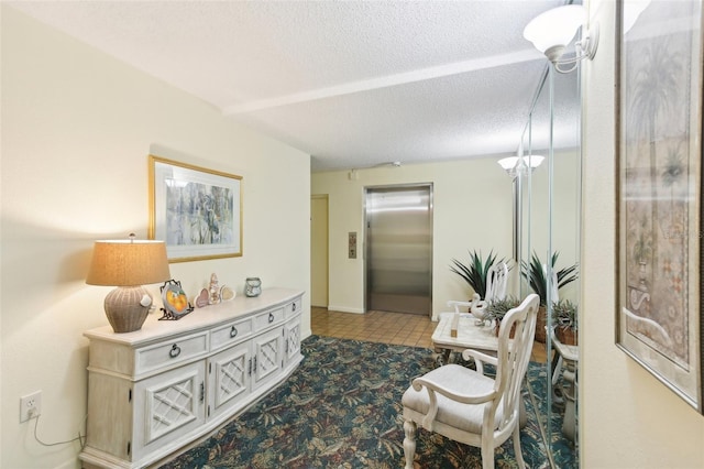 living area featuring elevator and a textured ceiling