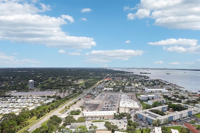 drone / aerial view featuring a view of city and a water view