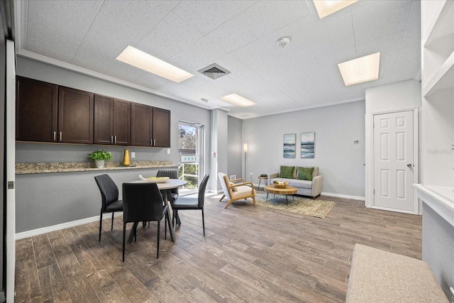 dining room featuring baseboards and wood finished floors