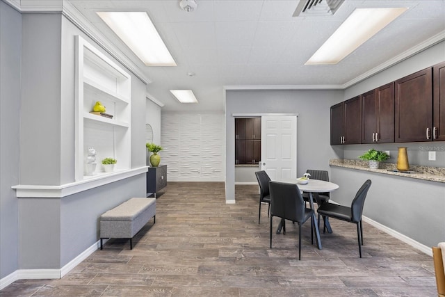 dining space with visible vents, baseboards, and wood finished floors