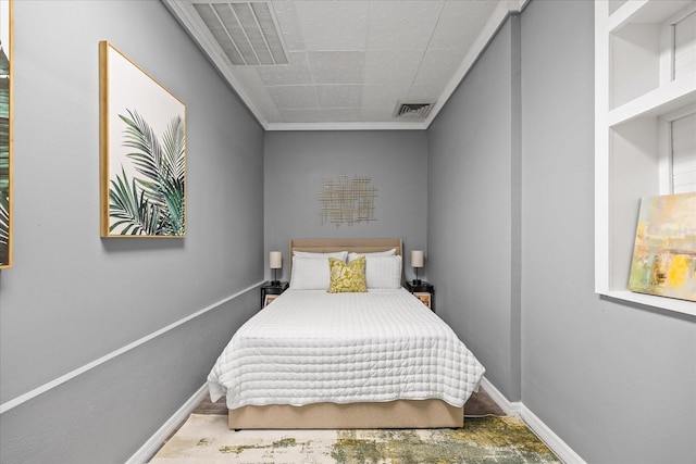 bedroom featuring visible vents, baseboards, and crown molding