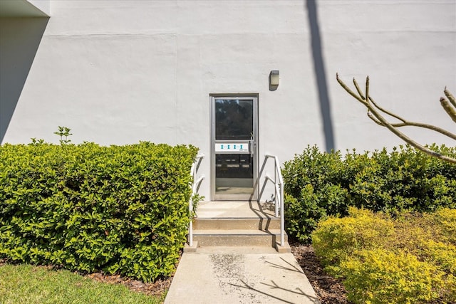 entrance to property featuring stucco siding