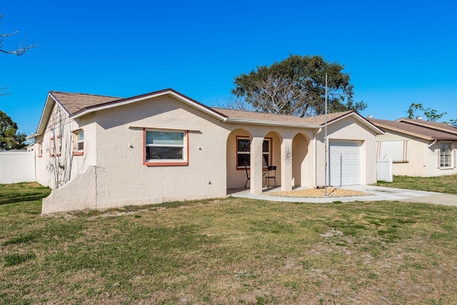 single story home with a front yard, an attached garage, and stucco siding