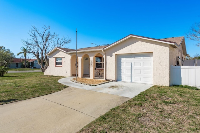 ranch-style home with a garage, driveway, stucco siding, fence, and a front yard