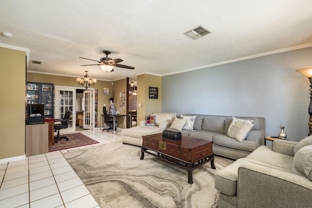 living room with tile patterned flooring, visible vents, crown molding, and a textured ceiling