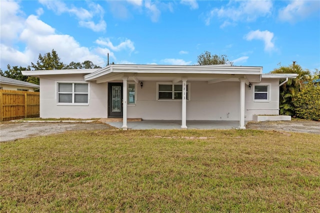 5813 18th Ave S, Gulfport, FL 33707 - rear view of house featuring stucco siding, a yard, a patio area, and fence