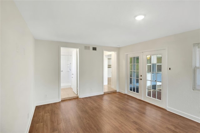 5813 18th Ave S, Gulfport, FL 33707 - spare room with french doors, baseboards, visible vents, and wood finished floors