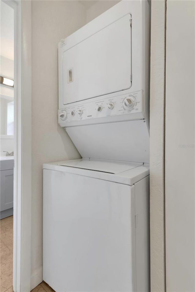 5813 18th Ave S, Gulfport, FL 33707 - clothes washing area featuring stacked washer / dryer and laundry area