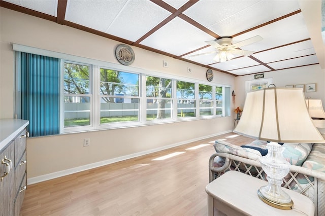 interior space with light wood-style flooring, baseboards, and a ceiling fan