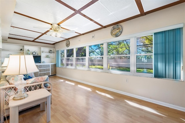 sunroom / solarium featuring ceiling fan