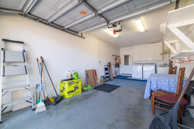 garage with separate washer and dryer, electric panel, and a garage door opener