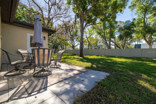 view of patio featuring outdoor dining area and fence