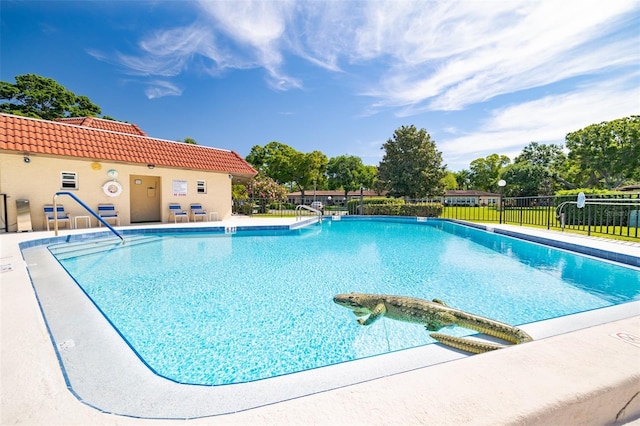 community pool featuring a patio area and fence