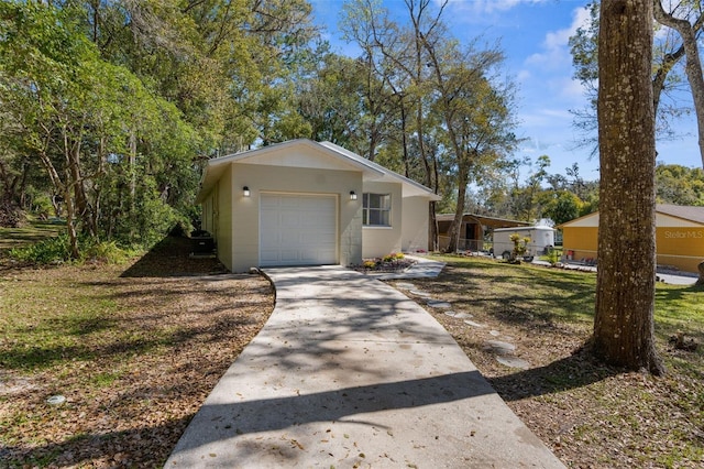 view of front facade with driveway, an attached garage, and fence