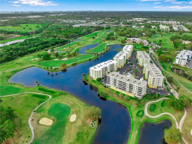 birds eye view of property with a view of city, a water view, and golf course view