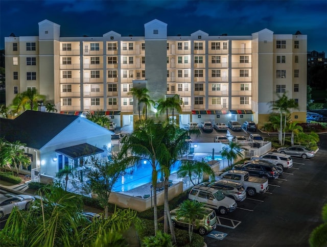 property at twilight featuring uncovered parking