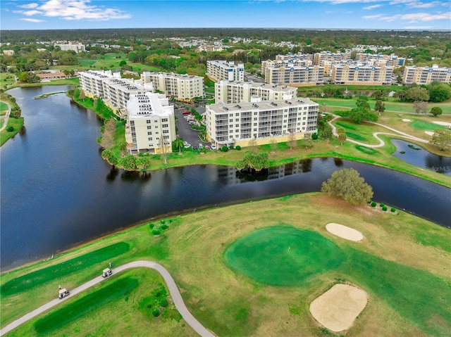 drone / aerial view featuring a view of city, a water view, and golf course view