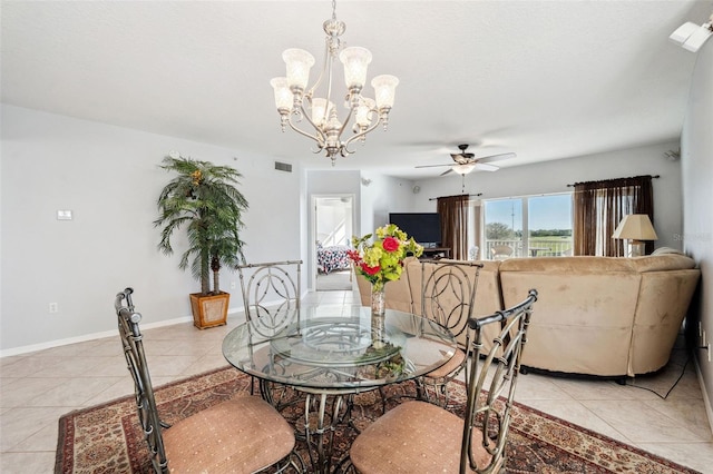 dining room featuring light tile patterned floors, ceiling fan with notable chandelier, visible vents, and baseboards