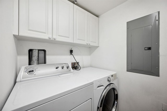 washroom with cabinet space, electric panel, and washer and dryer