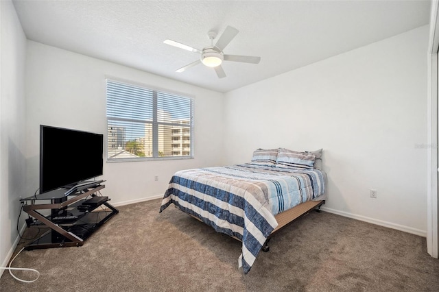 carpeted bedroom featuring ceiling fan and baseboards