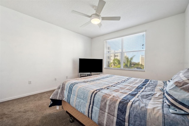 bedroom with a textured ceiling, carpet flooring, a ceiling fan, and baseboards