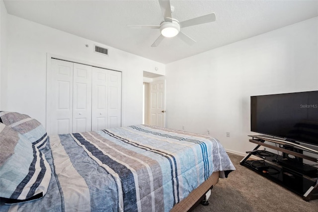 carpeted bedroom with ceiling fan, a closet, visible vents, and baseboards