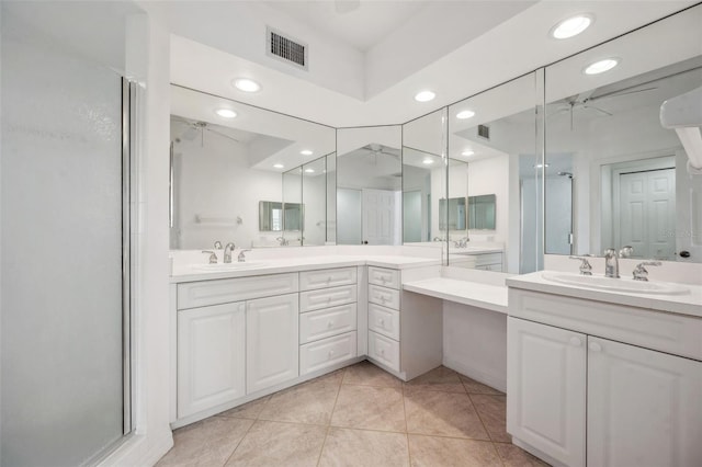 bathroom with ceiling fan, vanity, a shower stall, and visible vents