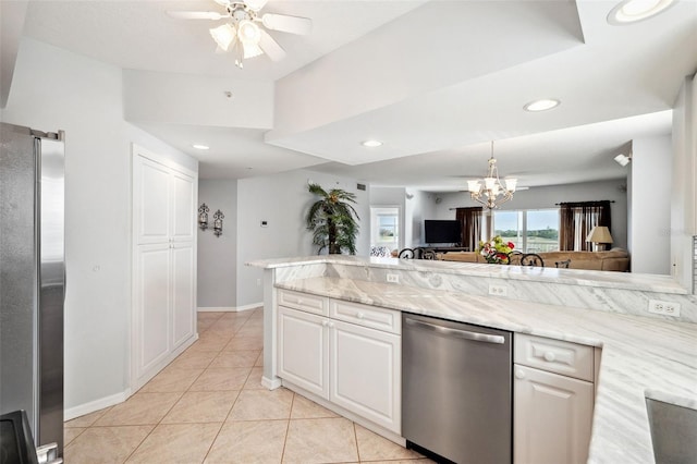 kitchen featuring light tile patterned floors, stainless steel appliances, light stone counters, and white cabinets