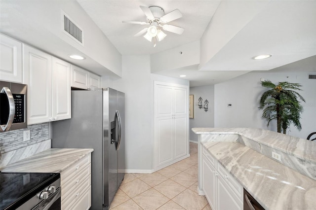 kitchen featuring light tile patterned floors, visible vents, backsplash, appliances with stainless steel finishes, and white cabinetry