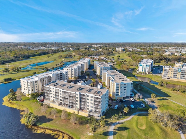 bird's eye view featuring a water view, view of golf course, and a city view