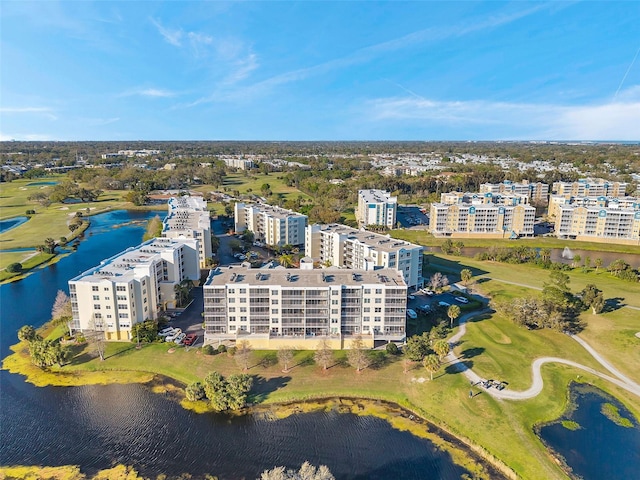 bird's eye view featuring a water view, view of golf course, and a city view