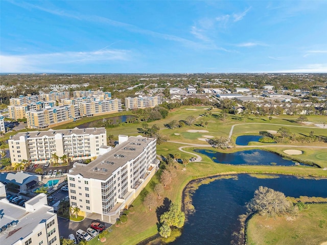 birds eye view of property featuring a view of city, view of golf course, and a water view