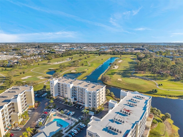 drone / aerial view featuring view of golf course and a water view