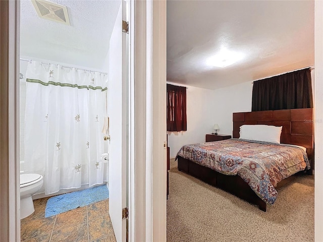 bedroom with visible vents and a textured ceiling