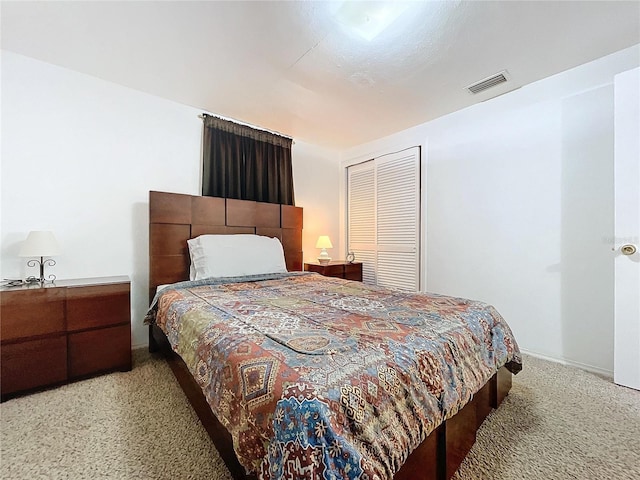 bedroom featuring visible vents and light colored carpet