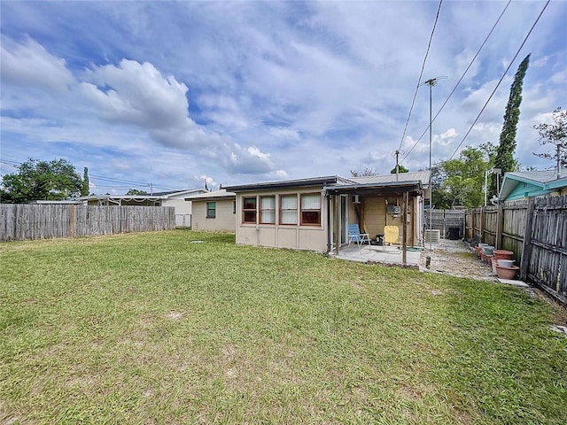 back of house with a patio area, a fenced backyard, and a yard