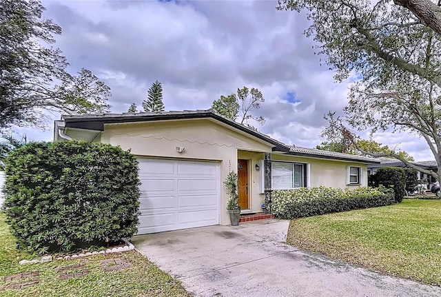 ranch-style home featuring a garage, driveway, a front yard, and stucco siding