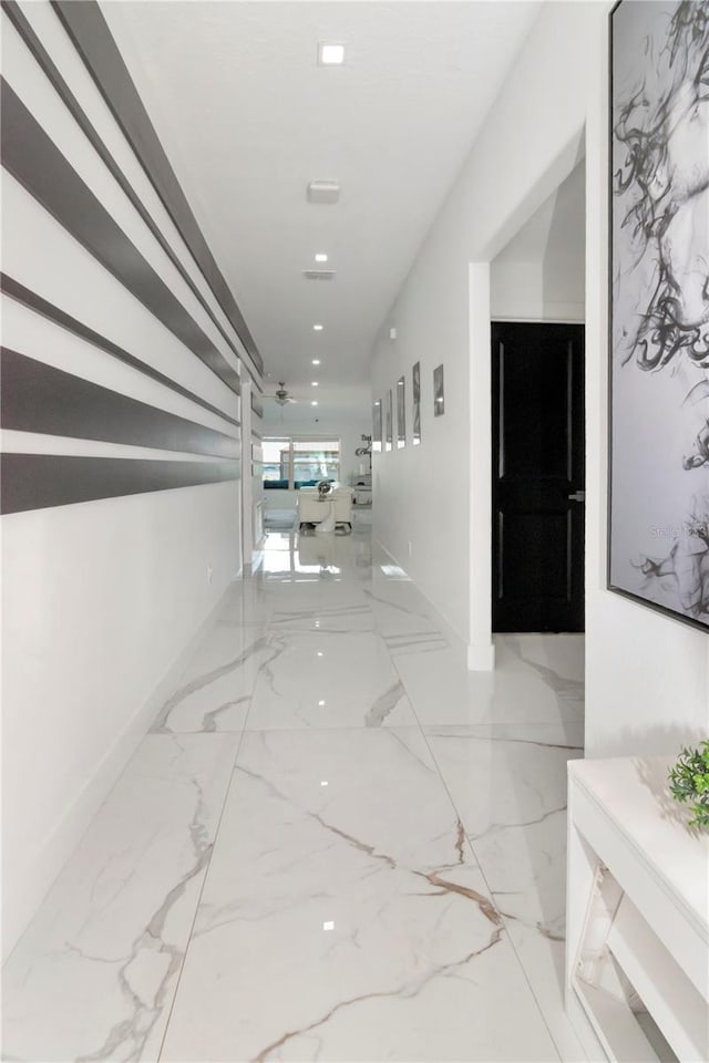 hall with marble finish floor, baseboards, and recessed lighting