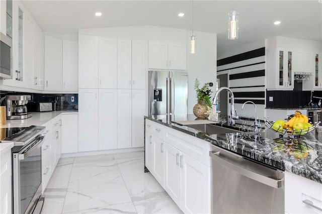 kitchen featuring recessed lighting, a sink, marble finish floor, appliances with stainless steel finishes, and glass insert cabinets