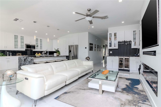 living room with beverage cooler, visible vents, ceiling fan, and recessed lighting