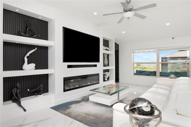 living room featuring lofted ceiling, marble finish floor, recessed lighting, and a glass covered fireplace