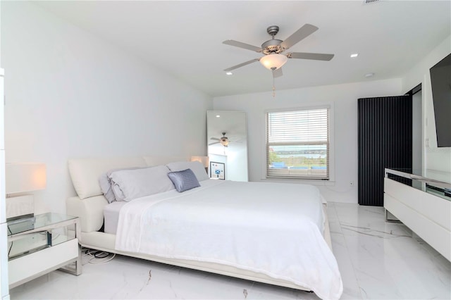 bedroom with marble finish floor and a ceiling fan