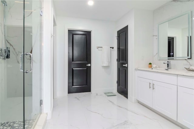 bathroom with marble finish floor, a marble finish shower, and vanity