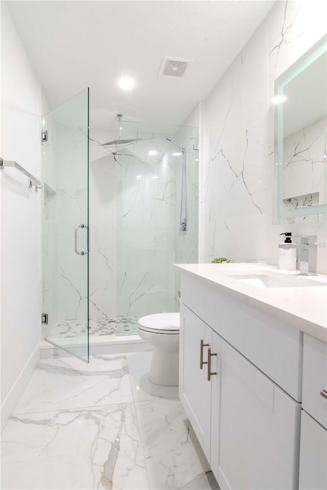 bathroom featuring marble finish floor, a marble finish shower, visible vents, toilet, and stone wall