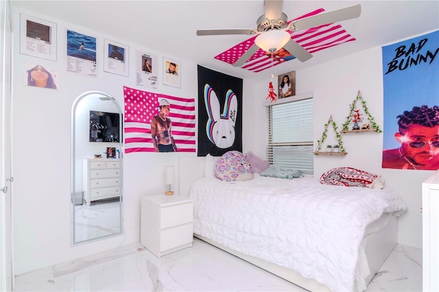 bedroom featuring marble finish floor and a ceiling fan