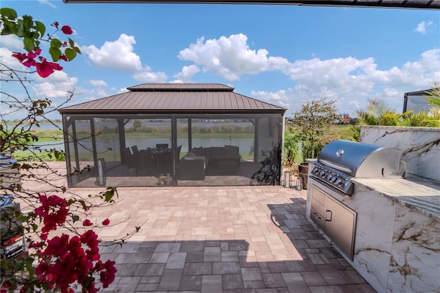 view of patio with an outdoor kitchen, area for grilling, and a gazebo