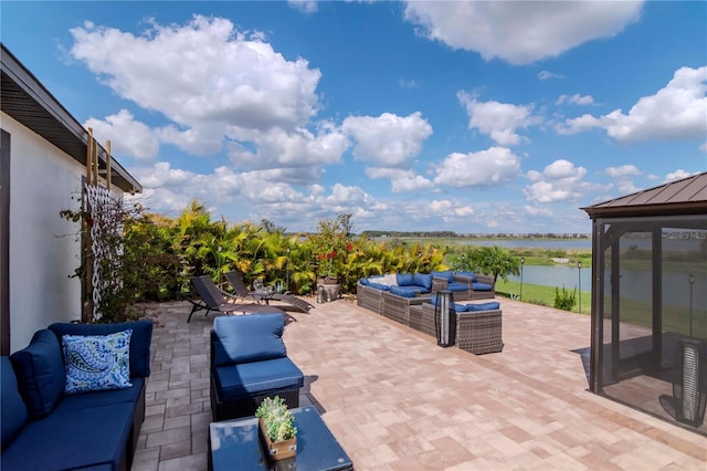 view of patio / terrace with a water view and outdoor lounge area