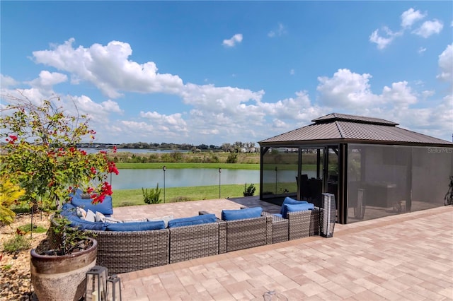 view of patio featuring a gazebo and a water view