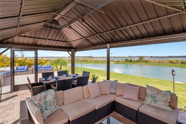 view of patio featuring a gazebo, outdoor dining area, a water view, and an outdoor living space