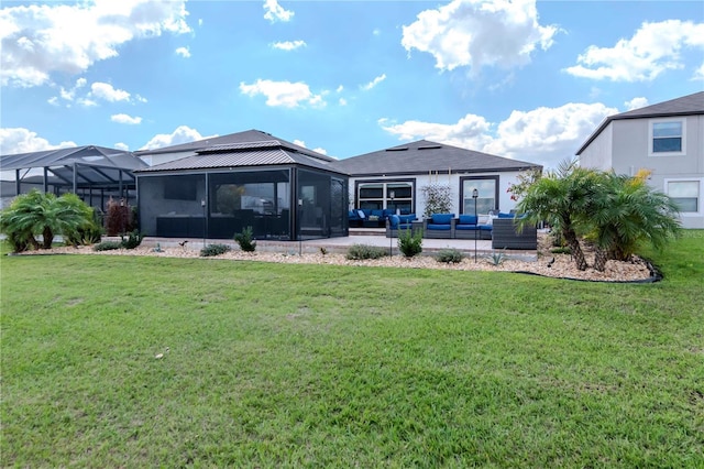 rear view of house with a patio area, an outdoor living space, and a lawn